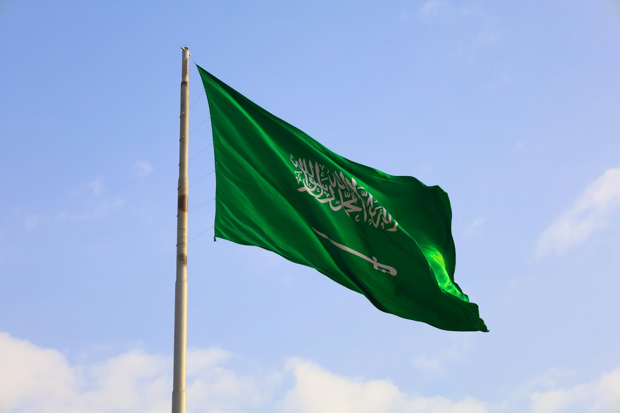 Saudi Arabia national flag waving in sky - Saudi National Day